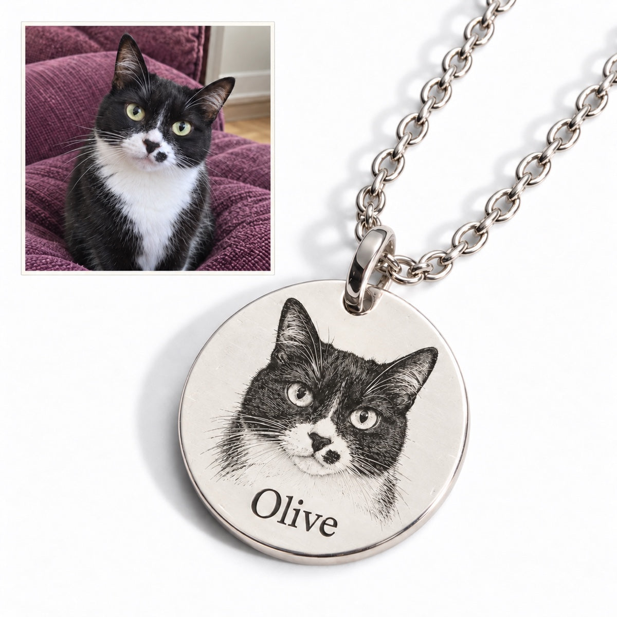 Cat — AI concept: casual indoor phone snapshot of Olive the tuxedo cat above a Silver engraved portrait necklace. Illustrative pet photo, not a customer photo or verified finished product.